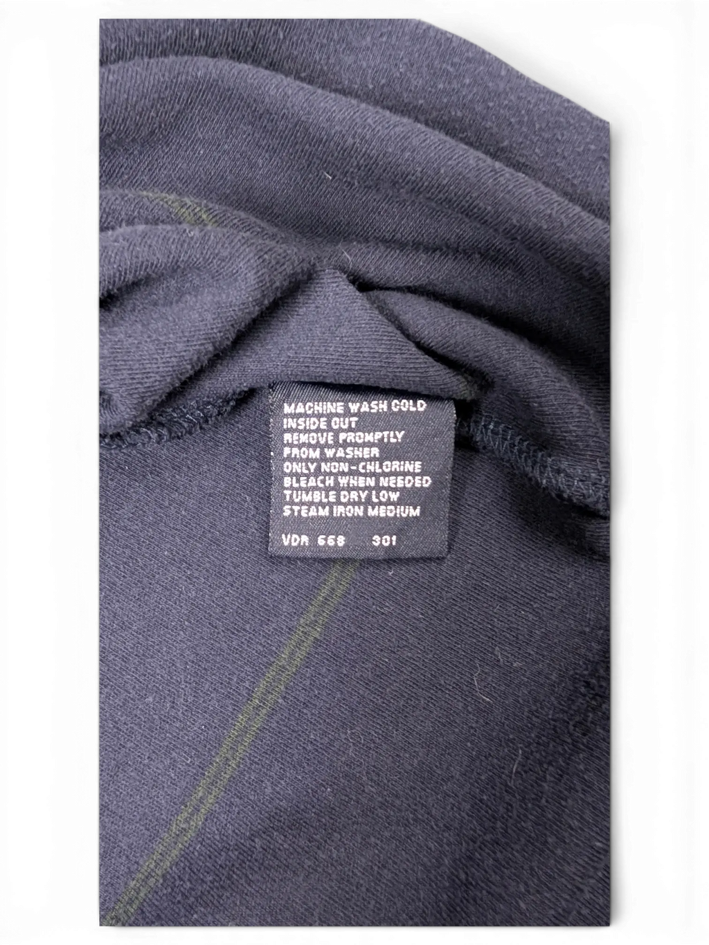 JAKE & IPI Nautica navy polo shirt care instruction label with fabric details
