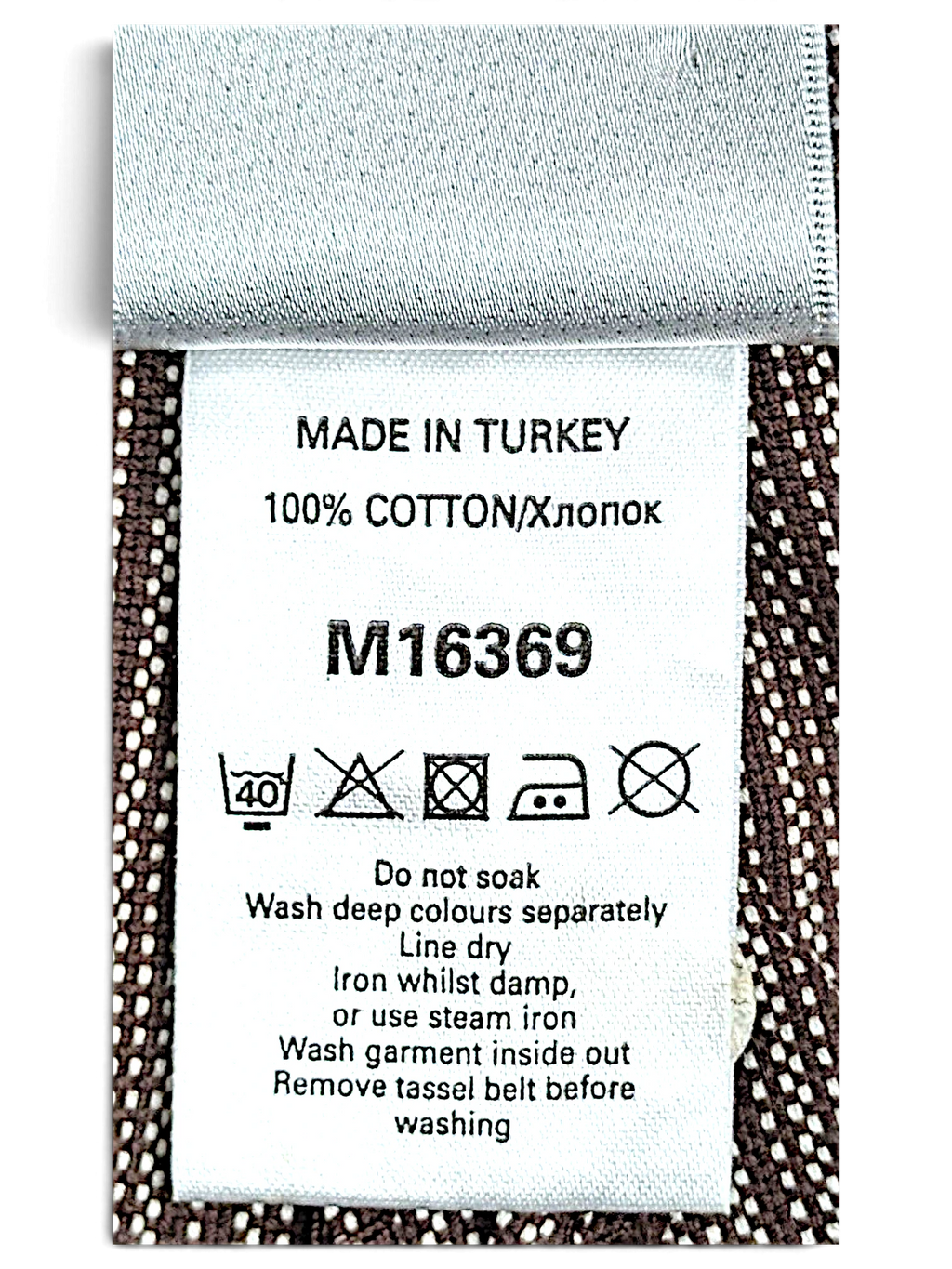 JAKE & IPI Next trousers care label showing 100% cotton composition and washing instructions on brown pinstripe fabric