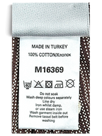 JAKE & IPI Next trousers care label showing 100% cotton composition and washing instructions on brown pinstripe fabric
