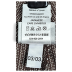JAKE & IPI Next trousers care label with Japanese symbols and fabric details on brown pinstripe cotton