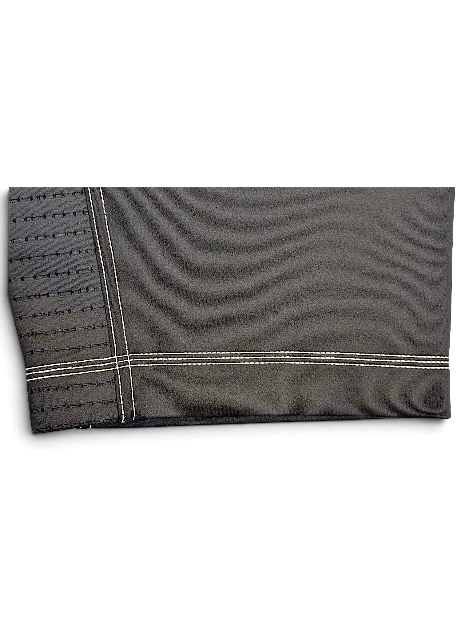 JAKE & IPI Nike Dri-FIT black performance track pants featuring detailed white contrast stitching and hem texture.