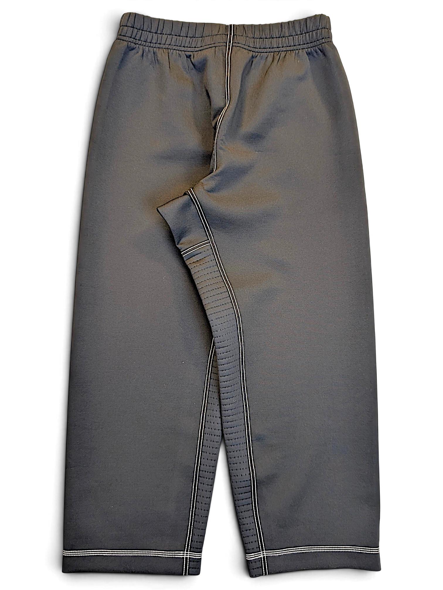 JAKE & IPI pre-owned Nike black Dri-FIT performance track pants with white contrast stitching and a streamlined fit.