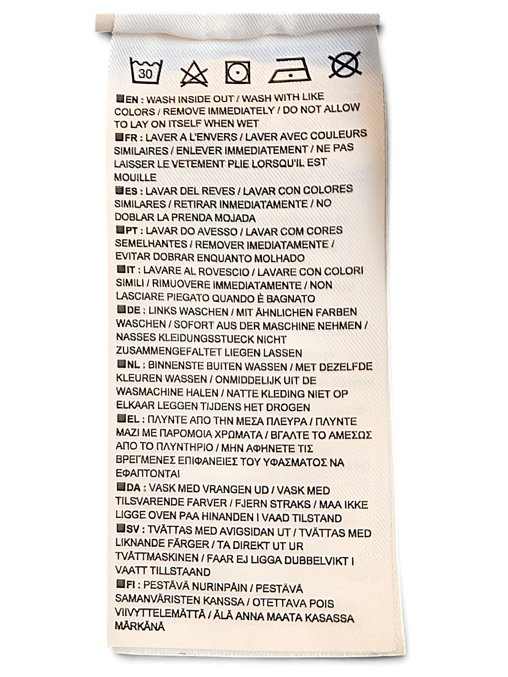 JAKE & IPI Nike track pants care label with washing instructions in multiple languages on a white polyester tag.