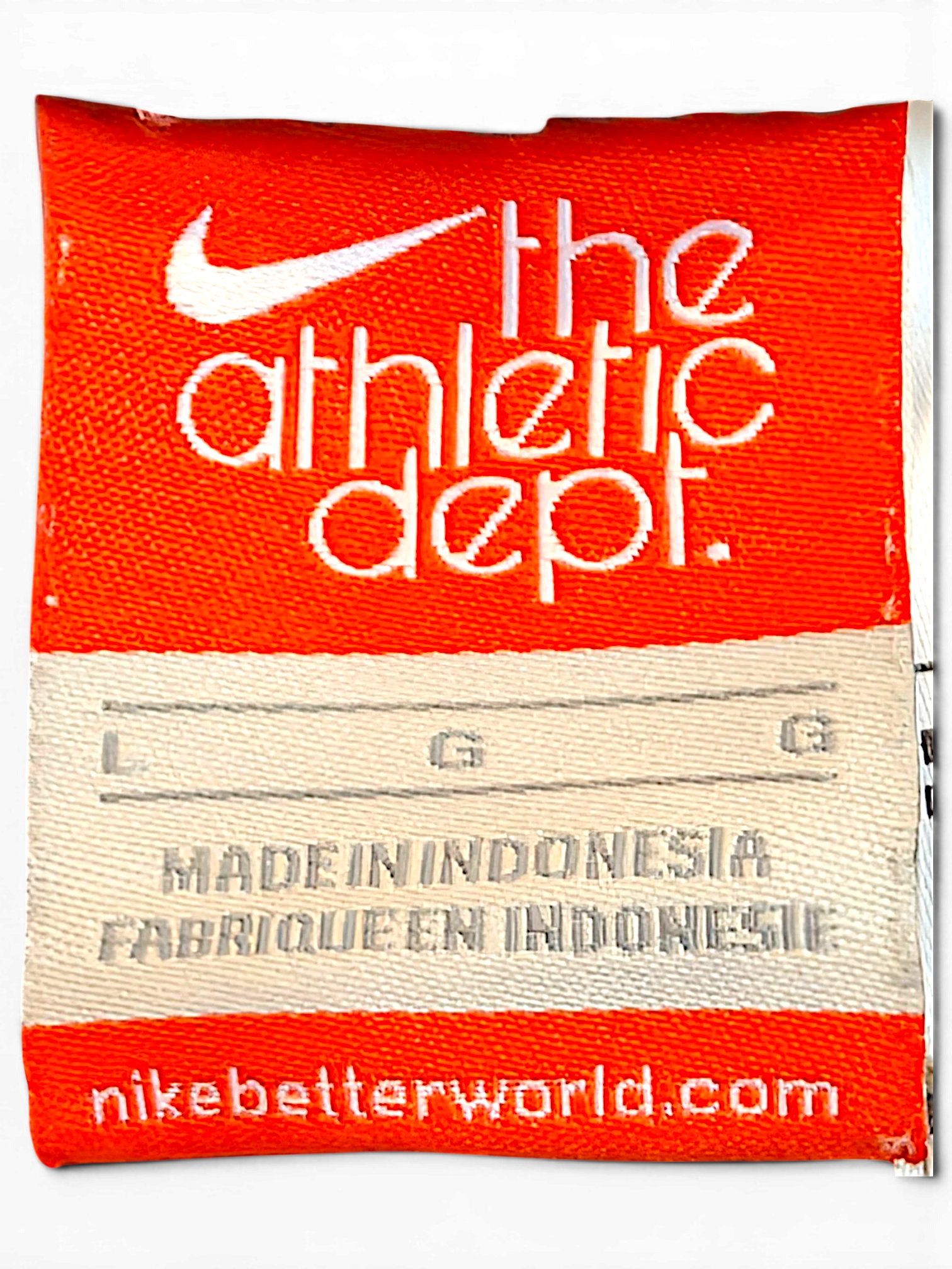 JAKE & IPI Nike athletic department clothing label in orange and white with size L indicator