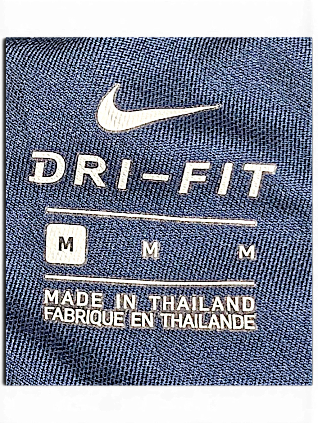 JAKE & IPI Nike Dri-FIT navy blue track pants interior size label showing size M and made in Thailand text