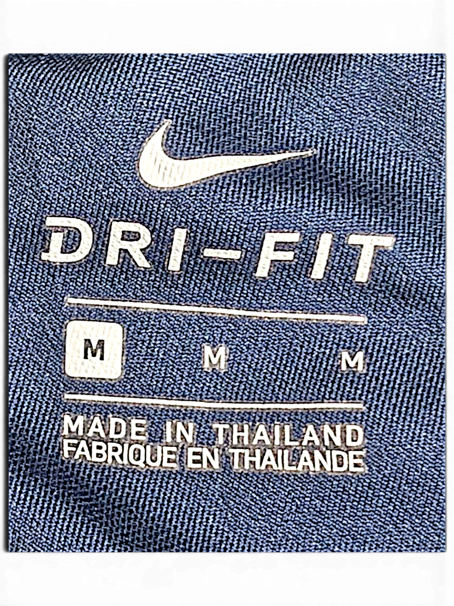 JAKE & IPI Nike Dri-FIT navy blue track pants interior size label showing size M and made in Thailand text