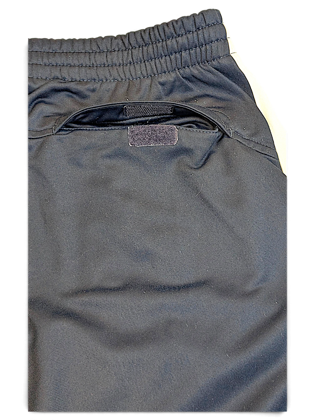 JAKE & IPI Nike navy track pants featuring an elasticated waistband and a secure velcro-closure back pocket.