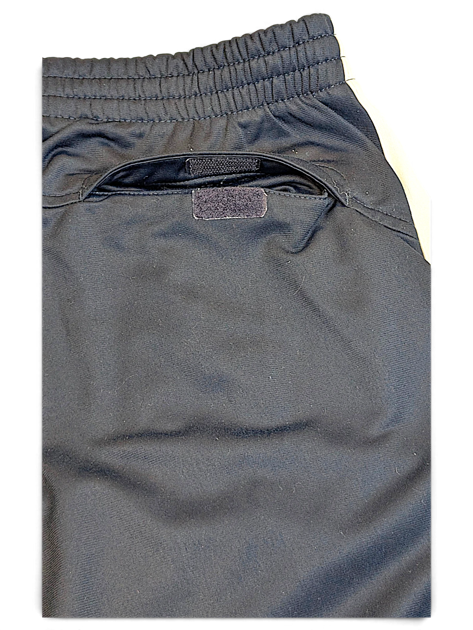 JAKE & IPI Nike navy track pants featuring an elasticated waistband and a secure velcro-closure back pocket.