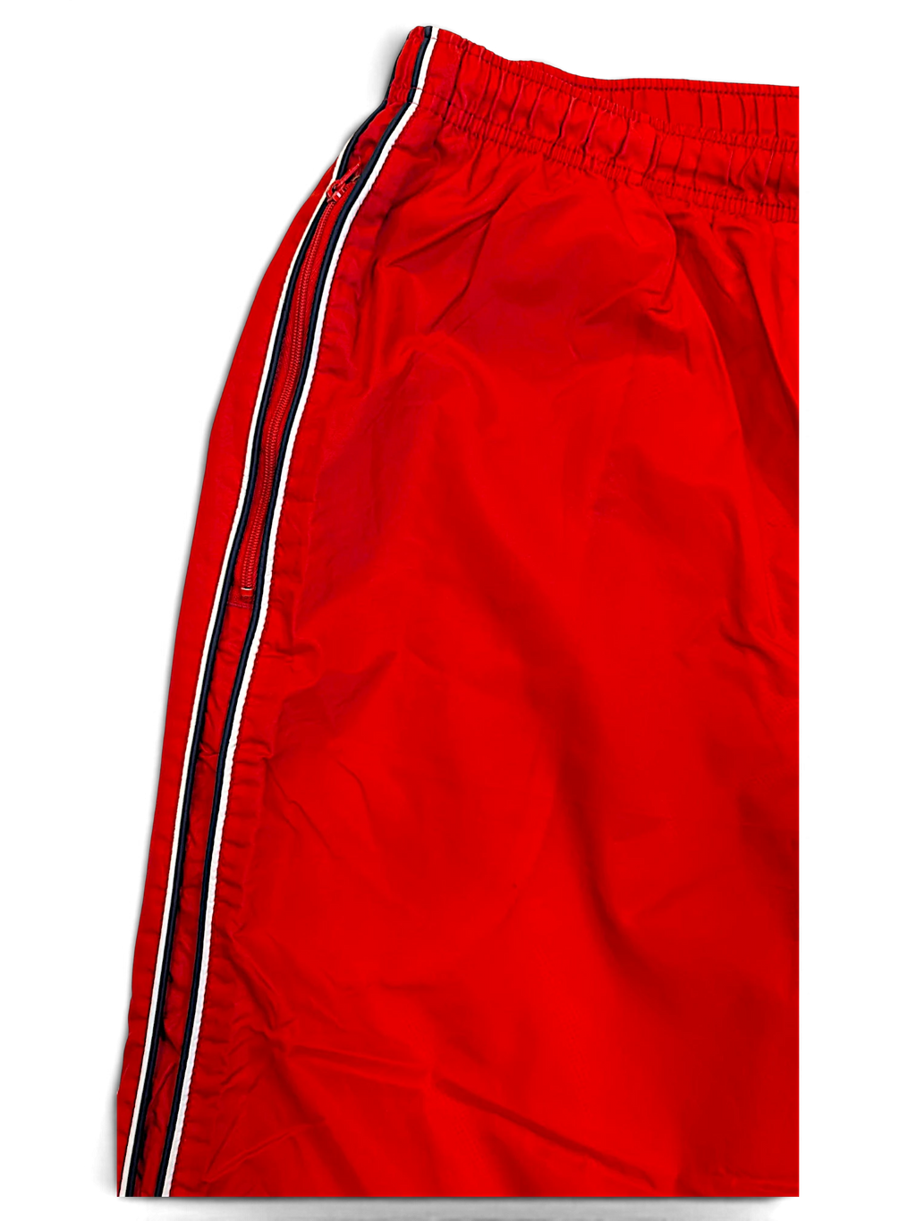 JAKE & IPI Nike red track pants featuring a black and white side stripe detail and an elasticated waistband.