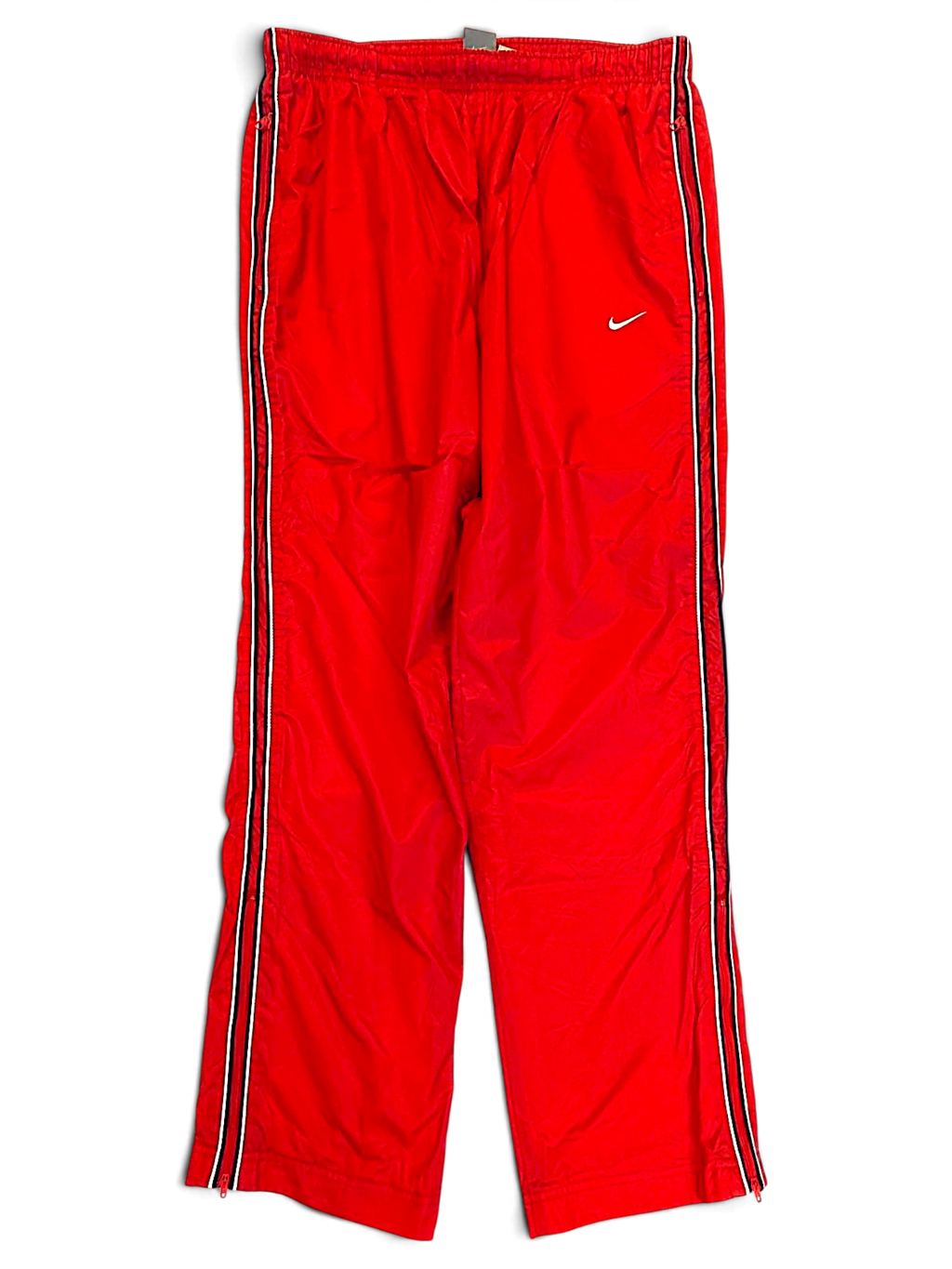 JAKE & IPI pre-owned red Nike track pants with black and white side stripes and white Swoosh logo