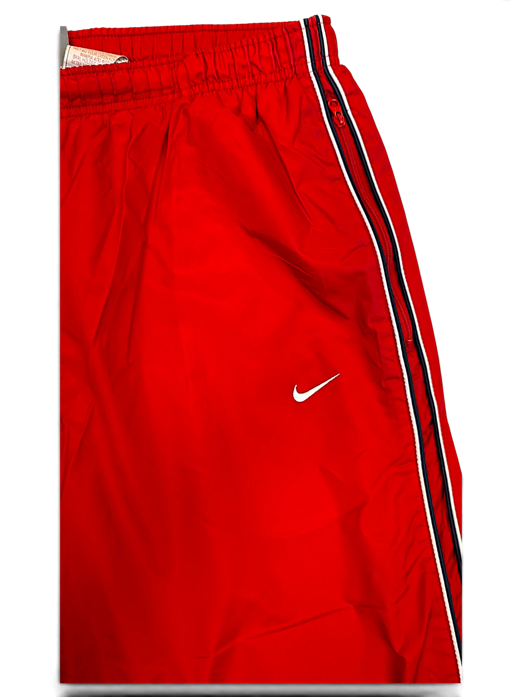 JAKE & IPI Nike red track pants with black and white side stripes and white Swoosh logo detail
