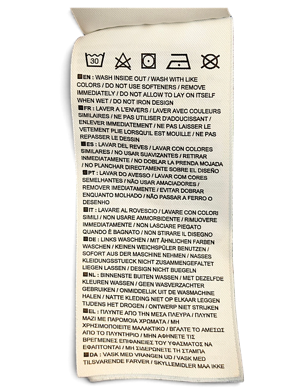 JAKE & IPI Nike track pants care label with washing instructions in multiple languages on a white fabric tag