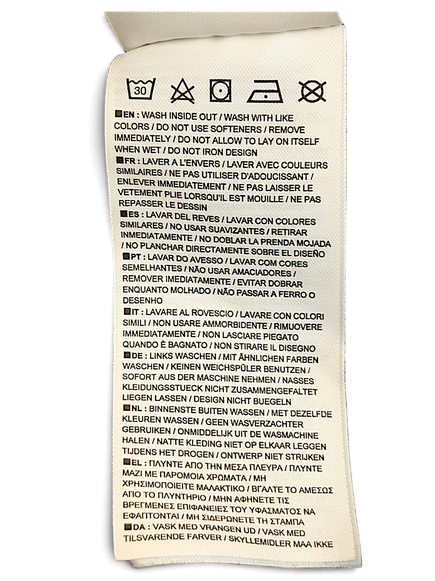 JAKE & IPI Nike track pants care label with washing instructions in multiple languages on a white fabric tag