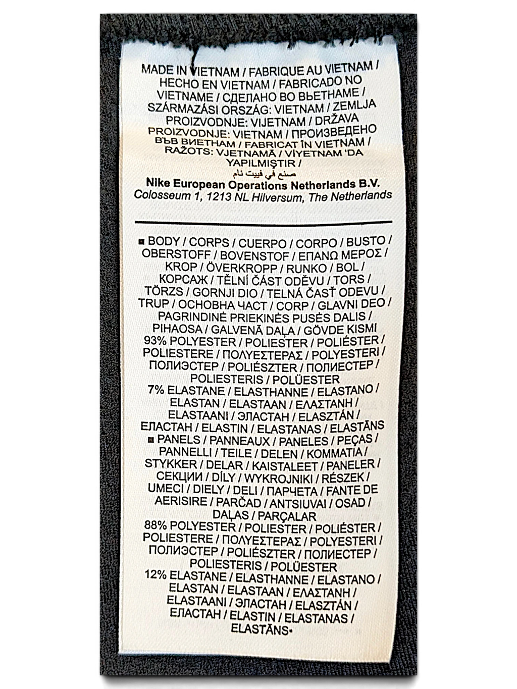 JAKE & IPI Nike track pants care label showing polyester and elastane fabric composition and Vietnam origin