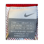 JAKE & IPI Nike track pants size L label showing Swoosh logo and manufacturing details