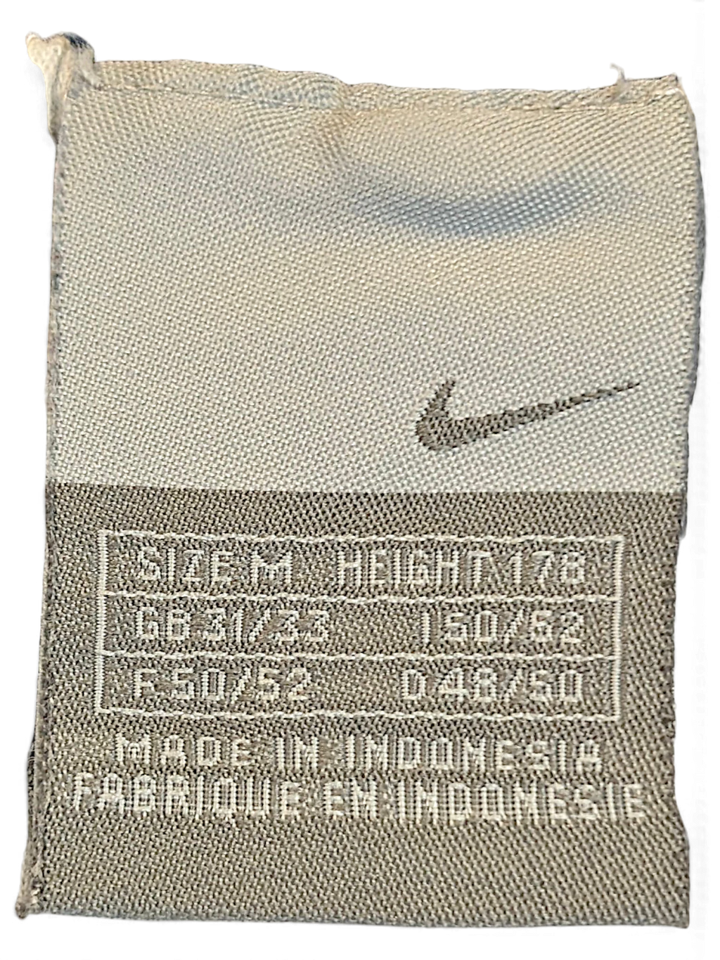 JAKE & IPI Nike navy windbreaker track pants size M clothing label with Swoosh logo and manufacturing details