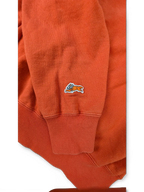 JAKE & IPI Icecream zip hoodie in bright orange featuring a small embroidered running dog logo on the sleeve cuff.