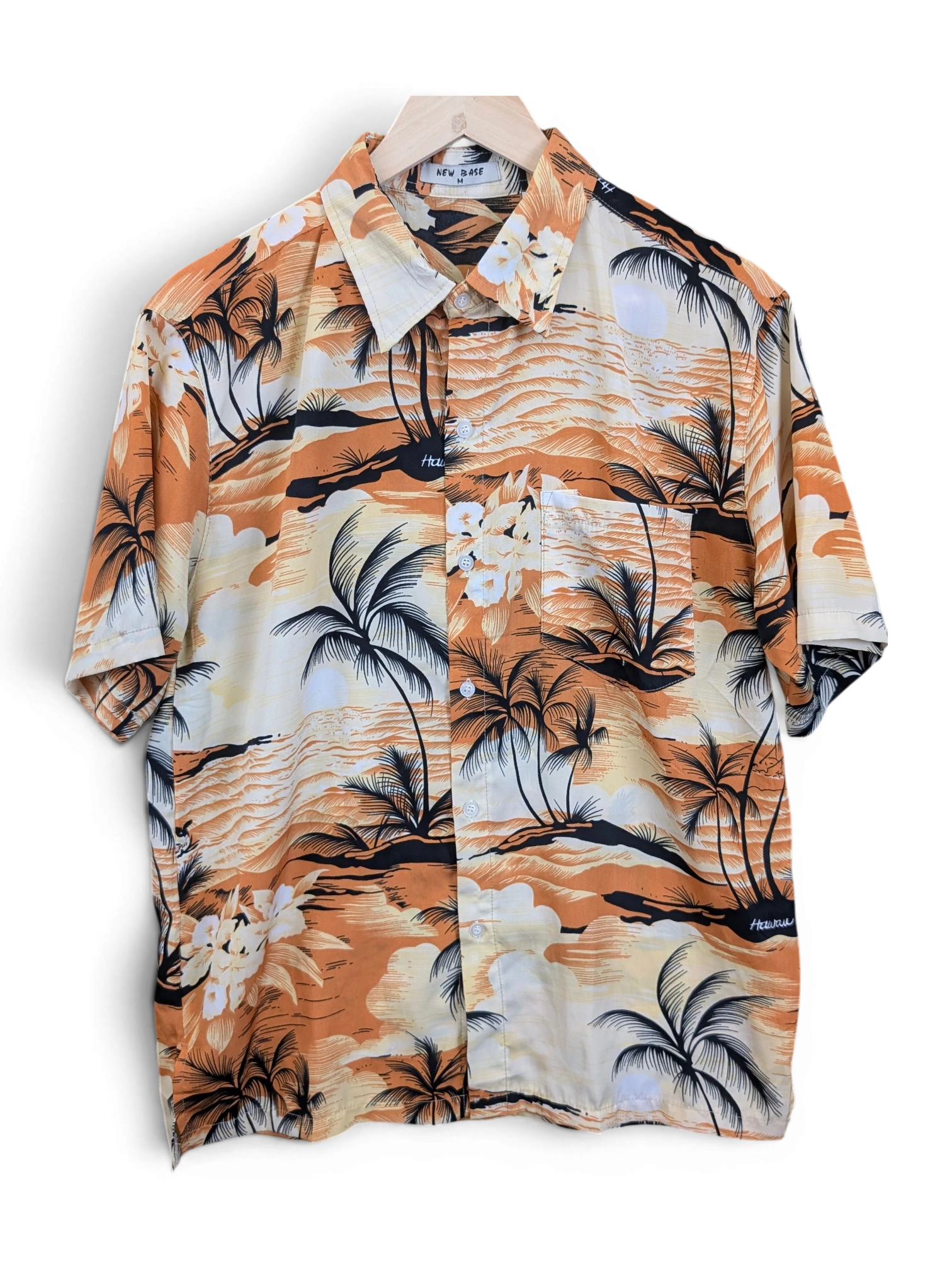 JAKE & IPI New Base Hawaiian shirt featuring a tropical palm tree and floral print in orange, black, and cream.