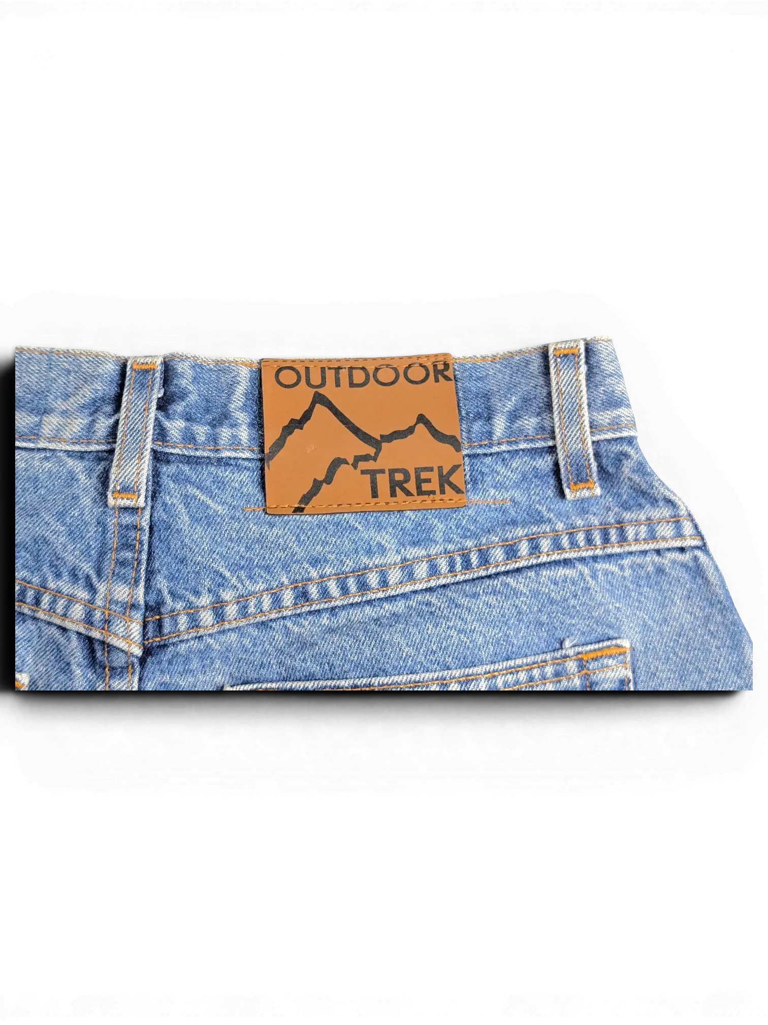 JAKE & IPI blue denim jeans featuring a brown leather patch with Outdoor Trek mountain graphic on the back waistband.