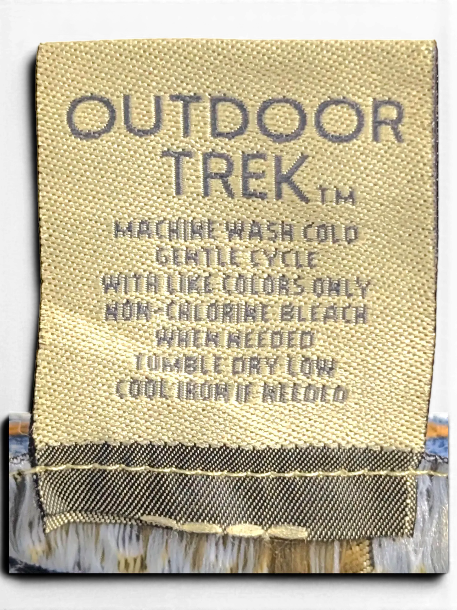 JAKE & IPI Outdoor Trek jeans interior care label with washing instructions on light blue denim fabric