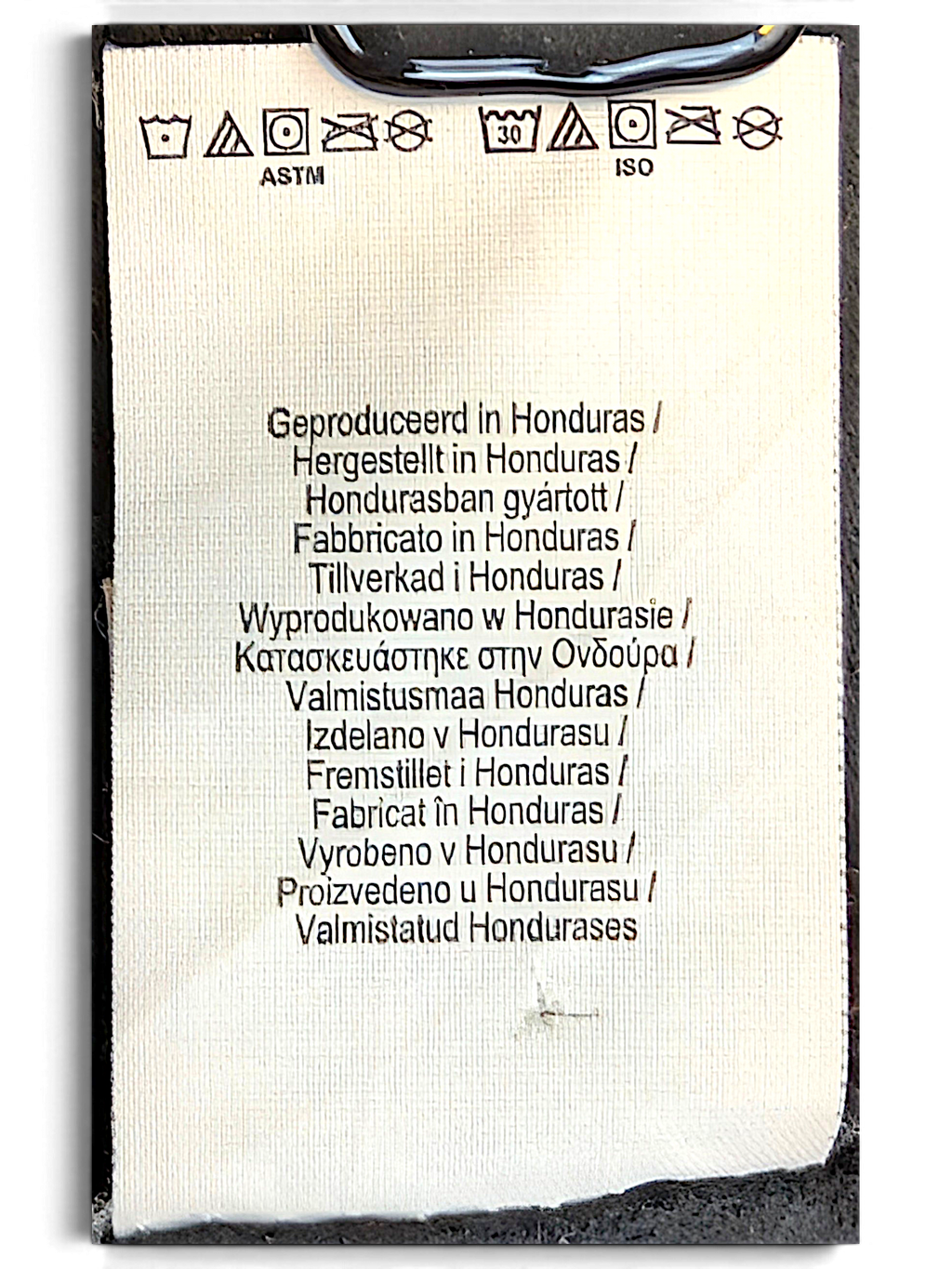 JAKE & IPI Outkast black hoodie interior care and origin label showing manufacturing details in multiple languages