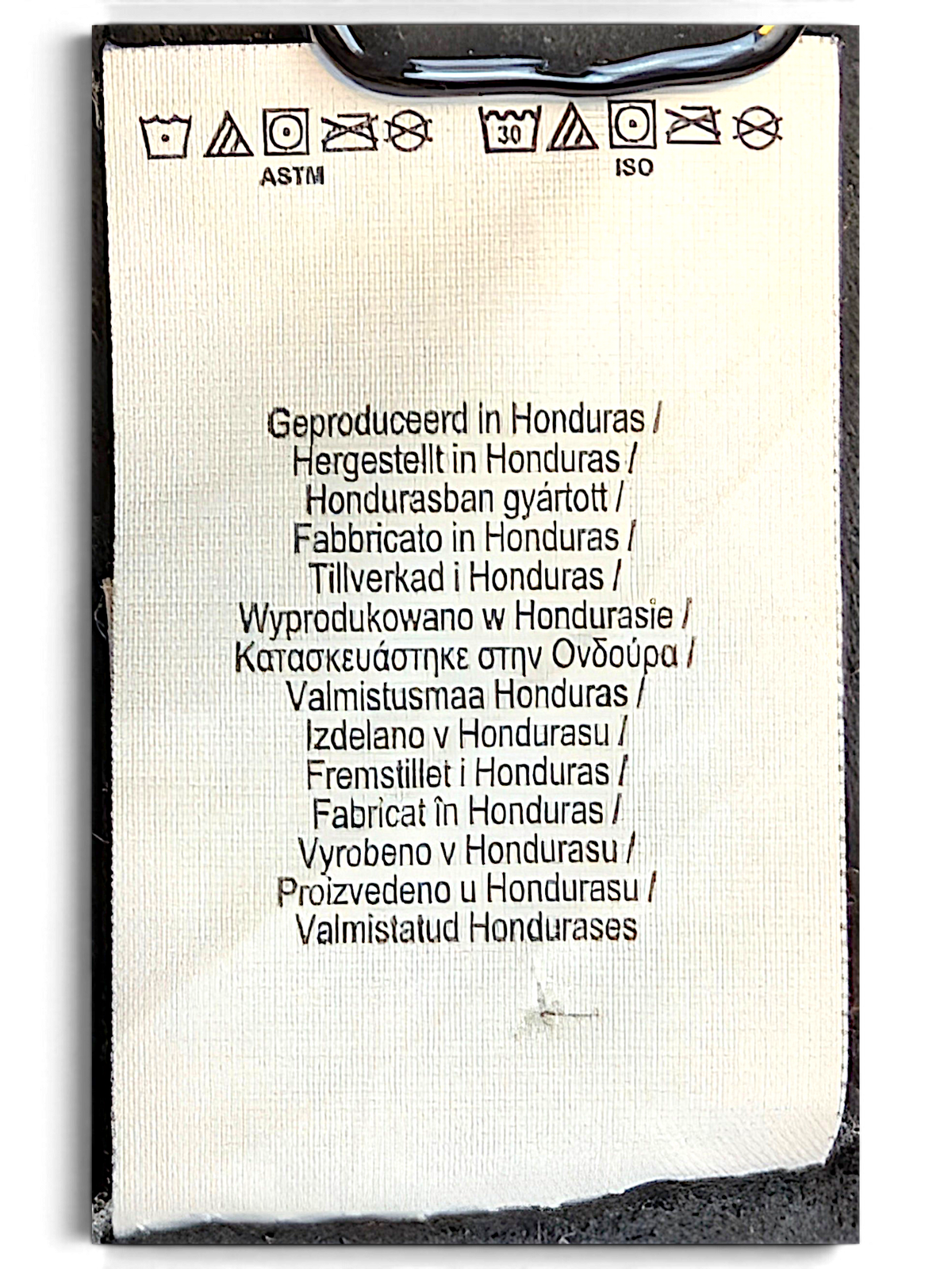 JAKE & IPI Outkast black hoodie interior care and origin label showing manufacturing details in multiple languages