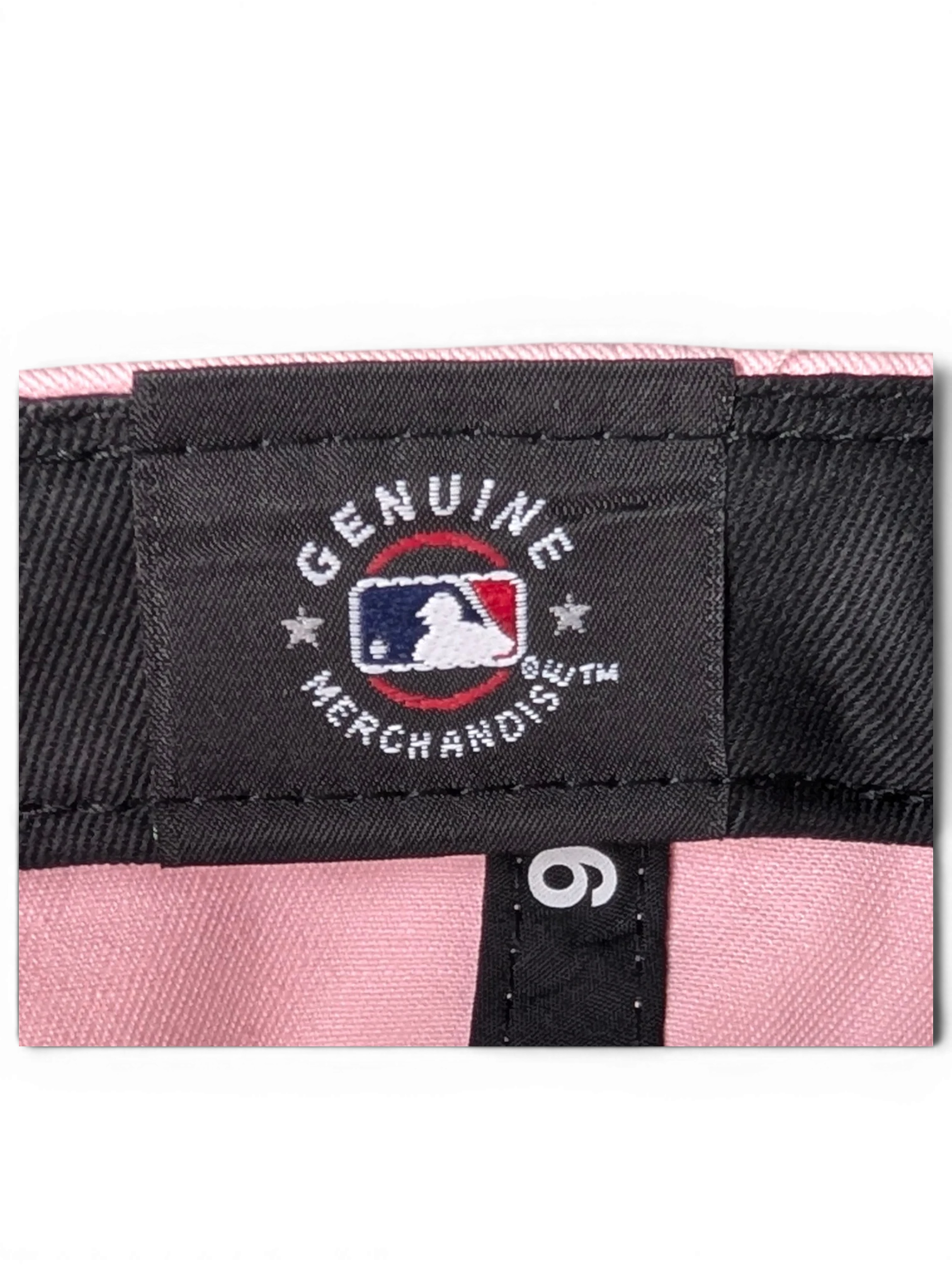 JAKE & IPI pink baseball cap interior showing Genuine Merchandise MLB branding and New Era label