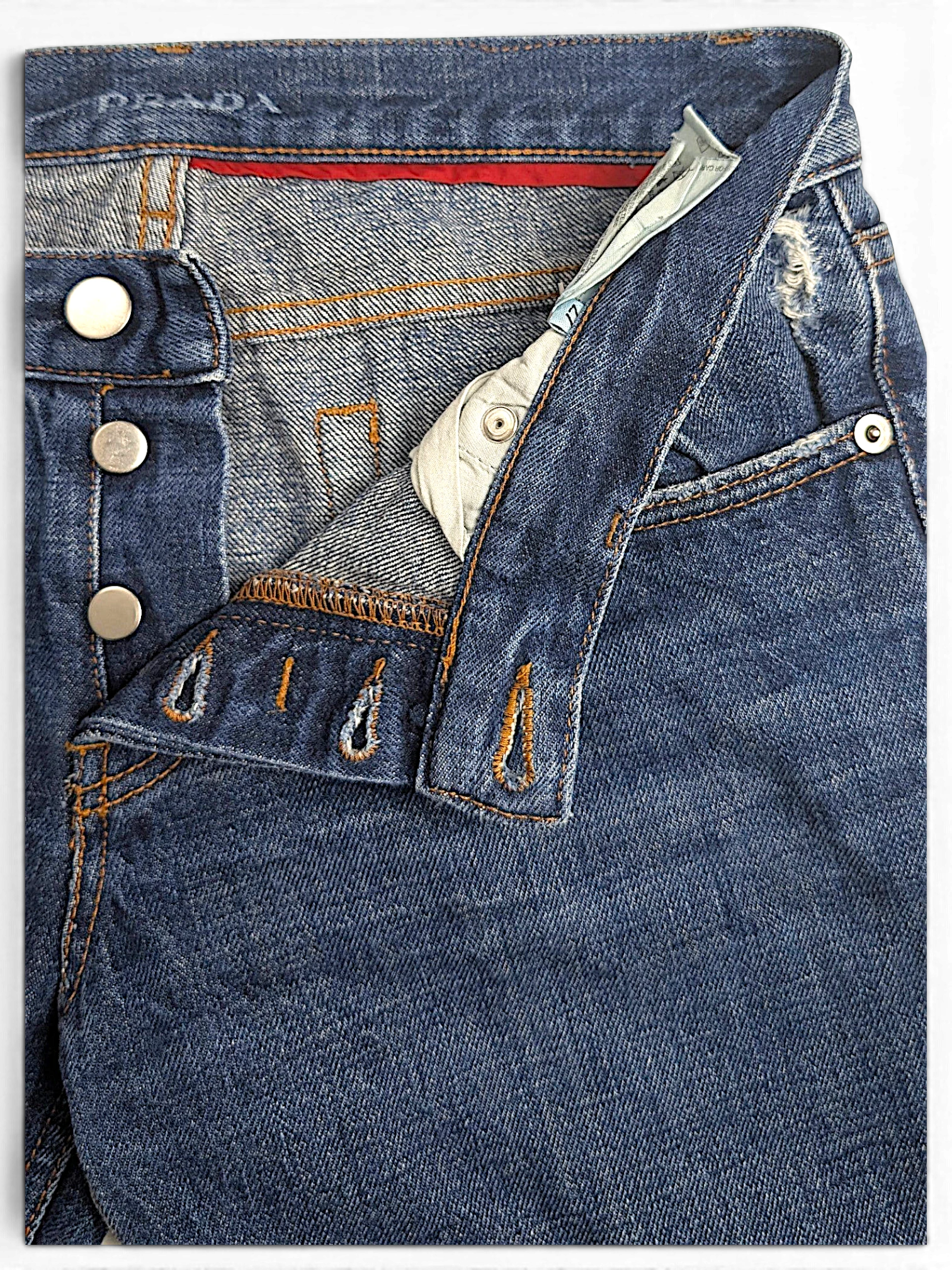 JAKE & IPI Prada blue cotton straight-leg jeans featuring a button fly and distressed pocket details.