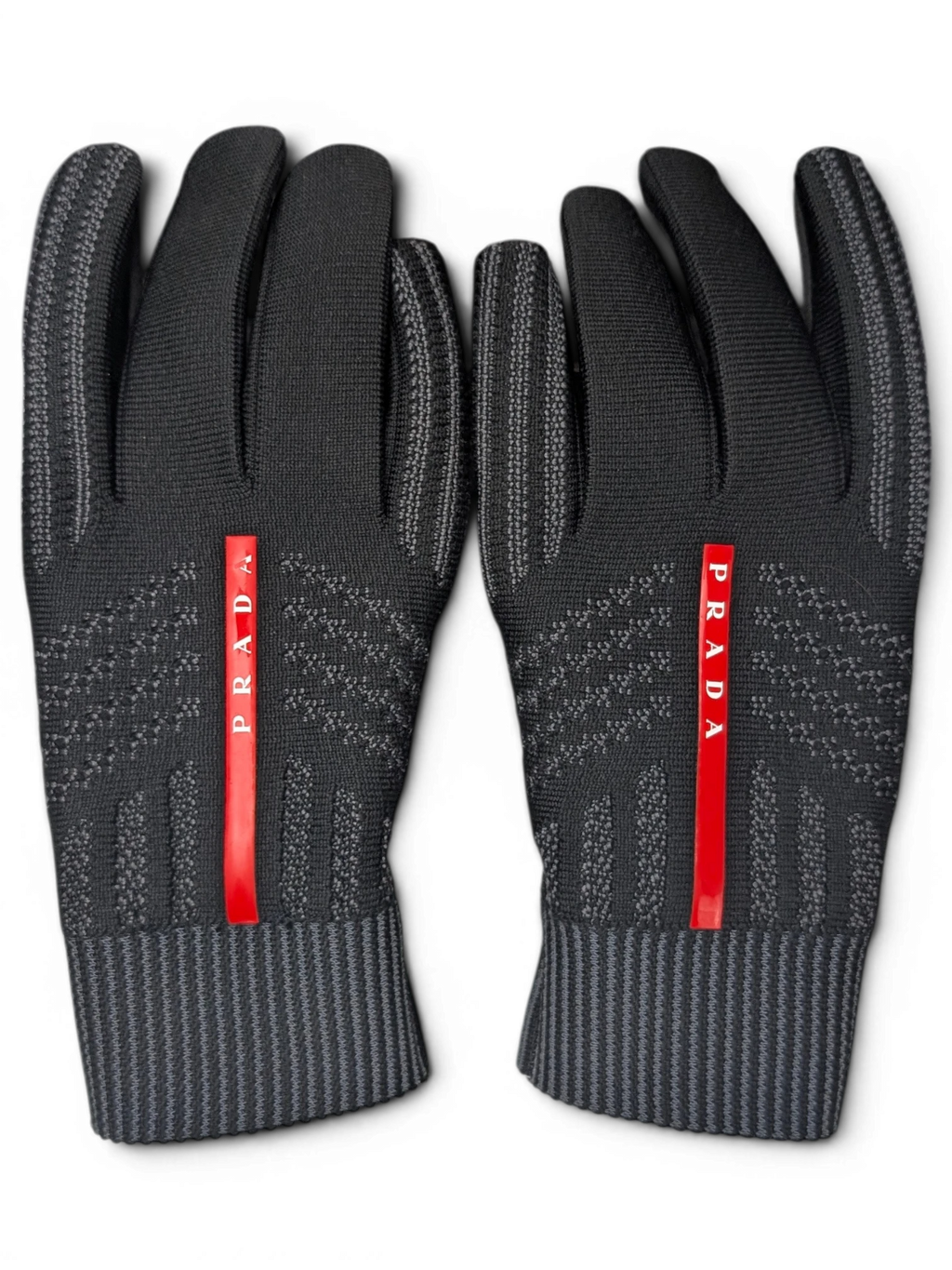 JAKE & IPI black Reusch for Prada knit gloves with red logo stripe and ribbed cuffs in a recycled cardboard box