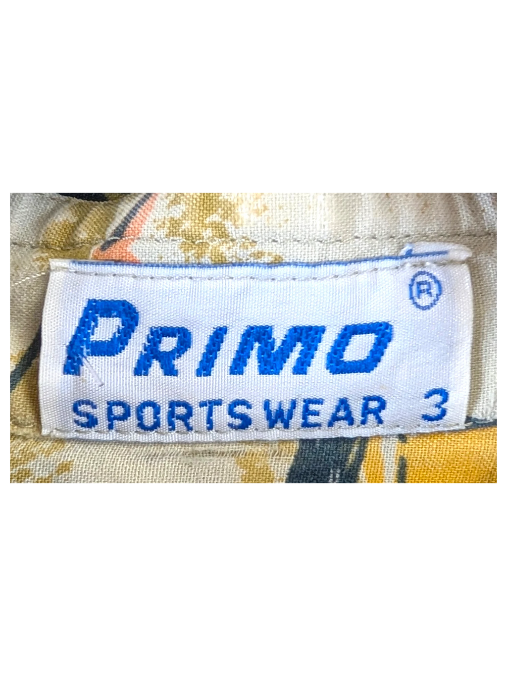 JAKE & IPI Primo SportsWear Hawaiian shirt label showing brand name and size 3 on a patterned fabric background