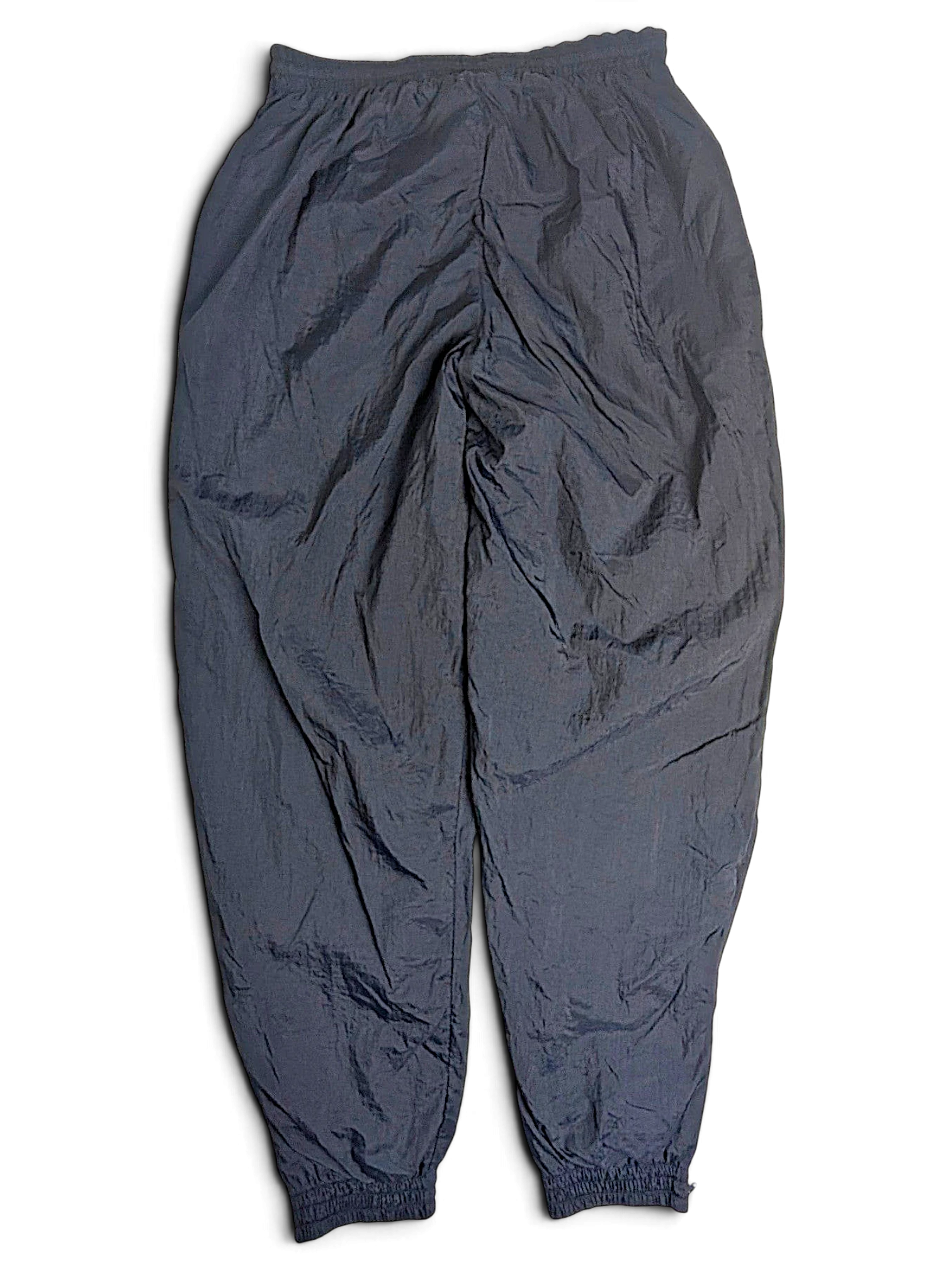 JAKE & IPI pre-owned black Puma lined track pants with an elastic waist and lightweight mixed-fabric construction.