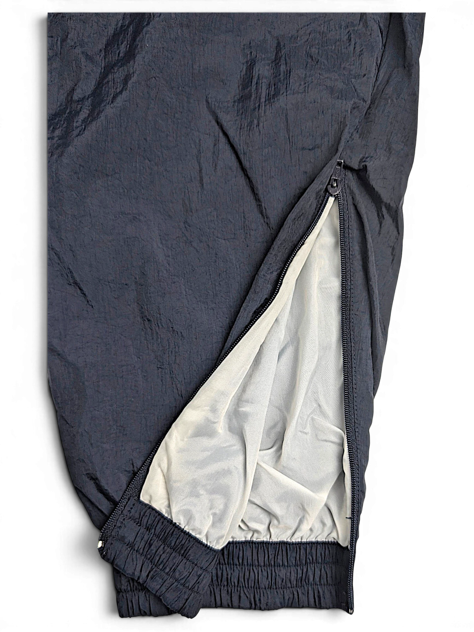 JAKE & IPI pre-owned black Puma track pants with side zipper detail and white lining