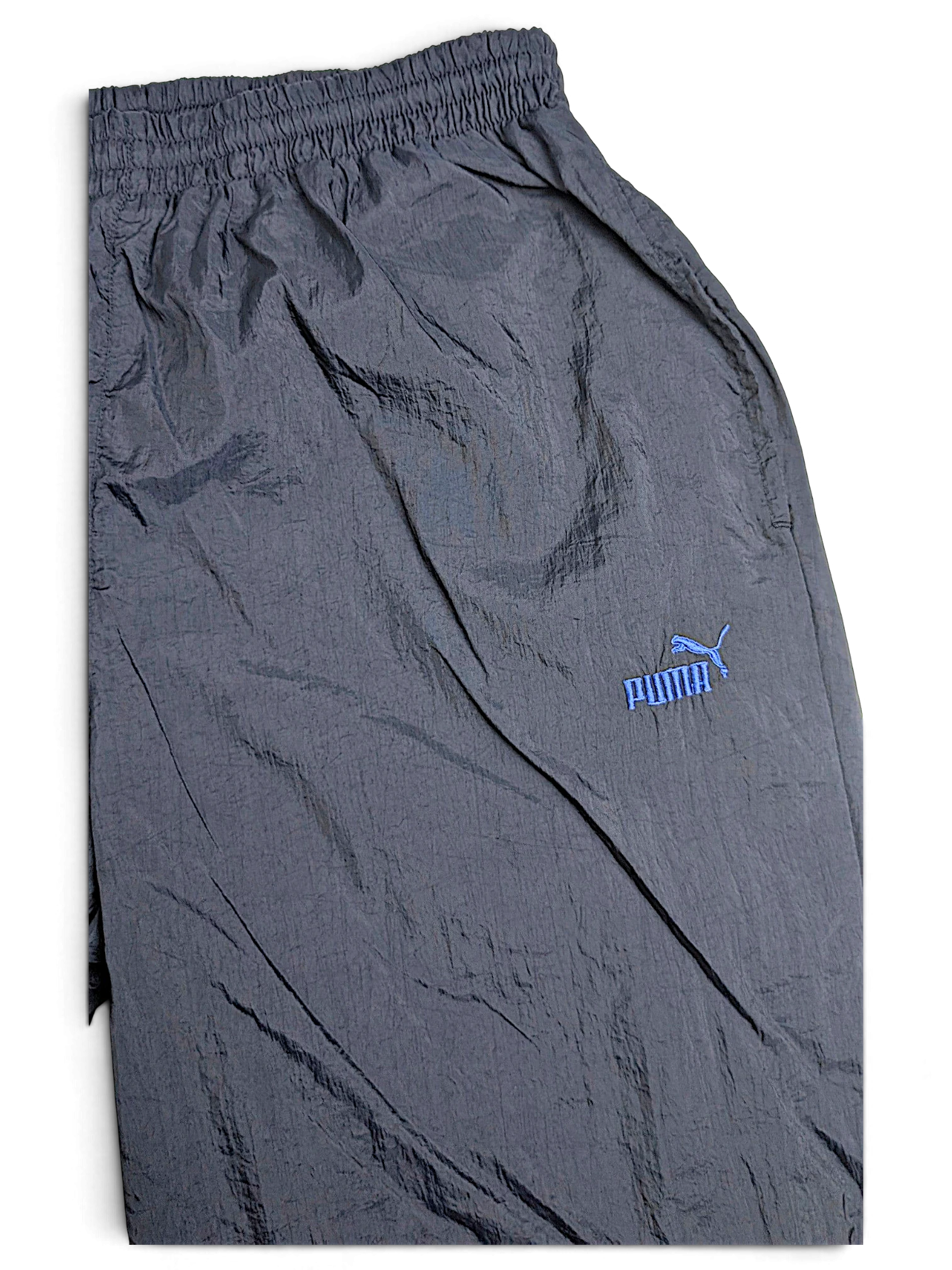 JAKE & IPI pre-owned black Puma track pants with light blue logo, elastic waist, and lightweight fabric construction.