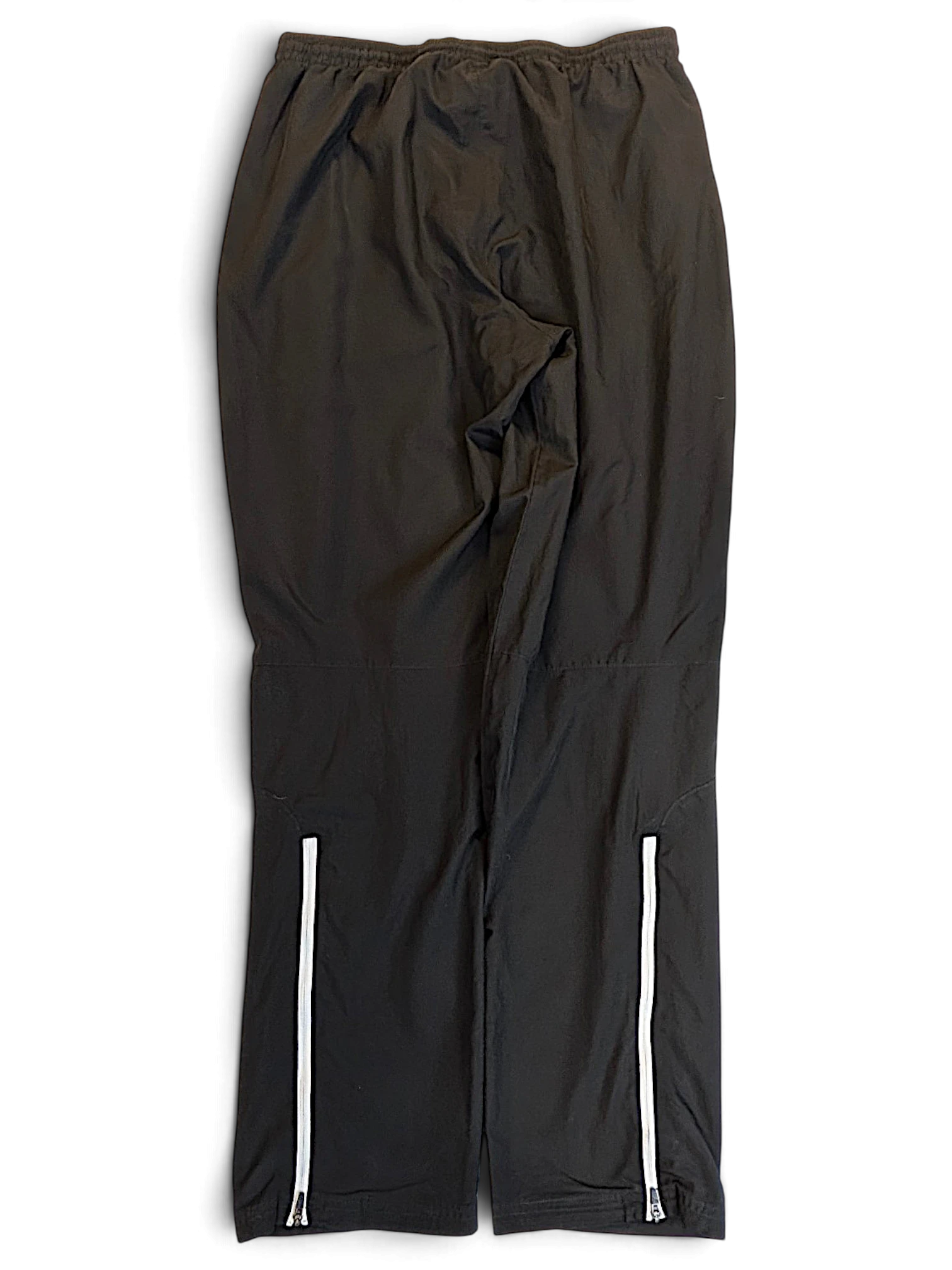 JAKE & IPI pre-owned black Puma track pants with white piping detail and zip hems in size M