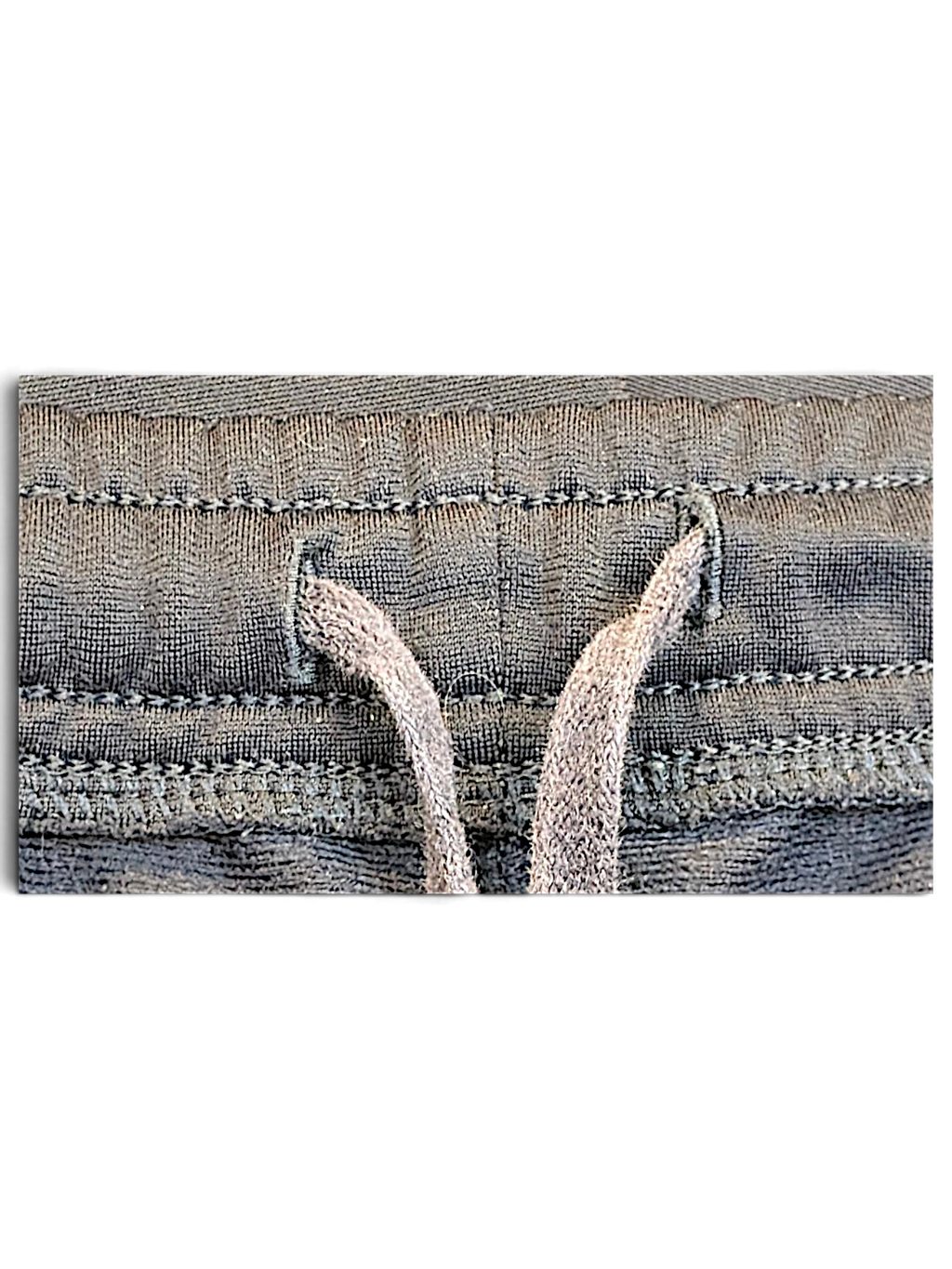Close-up of the navy elasticated drawstring waistband on pre-owned Puma track pants from JAKE & IPI