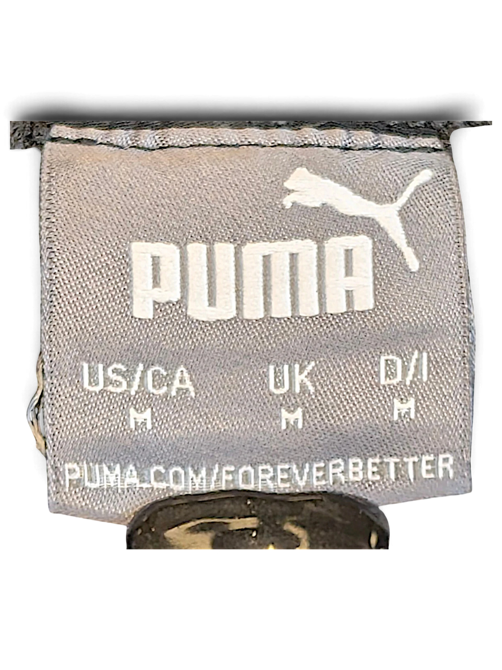 JAKE & IPI Puma track pants size M clothing label with white logo on grey fabric