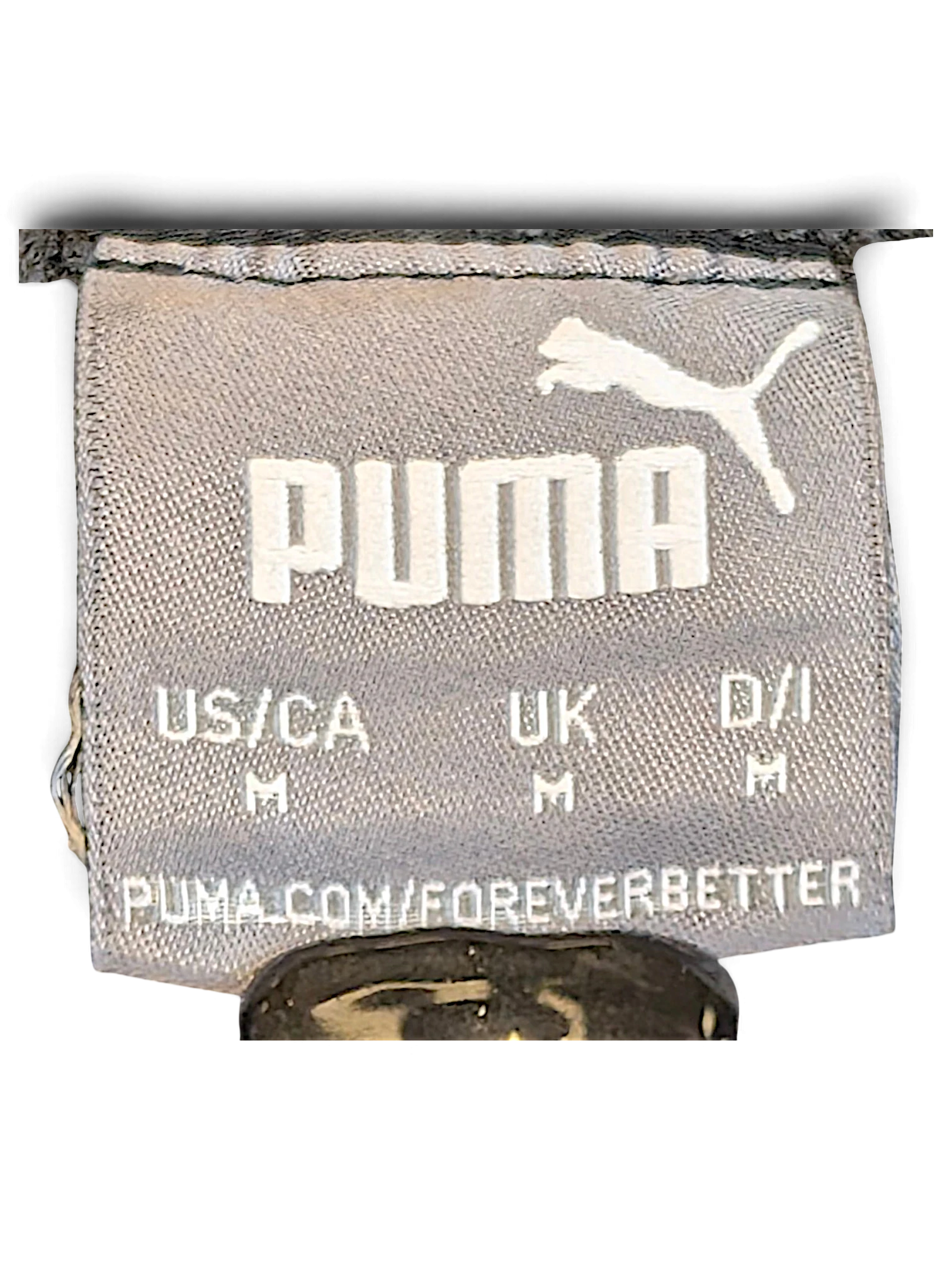 JAKE & IPI Puma track pants size M clothing label with white logo on grey fabric