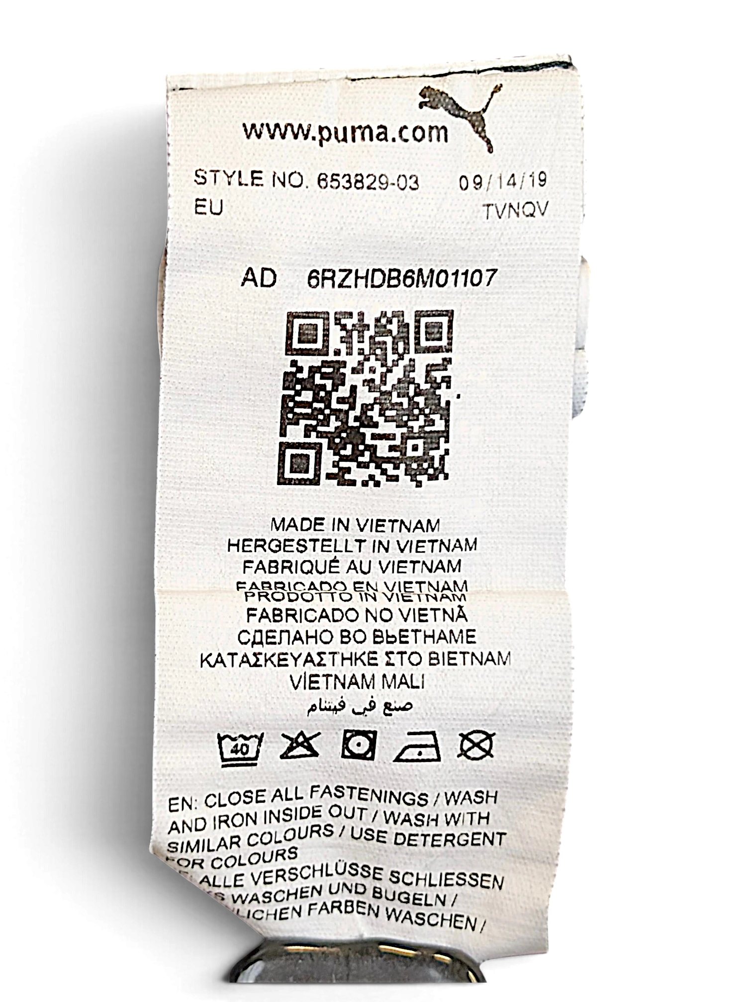 JAKE & IPI Puma track pants care label with washing instructions and manufacturing details in Vietnam