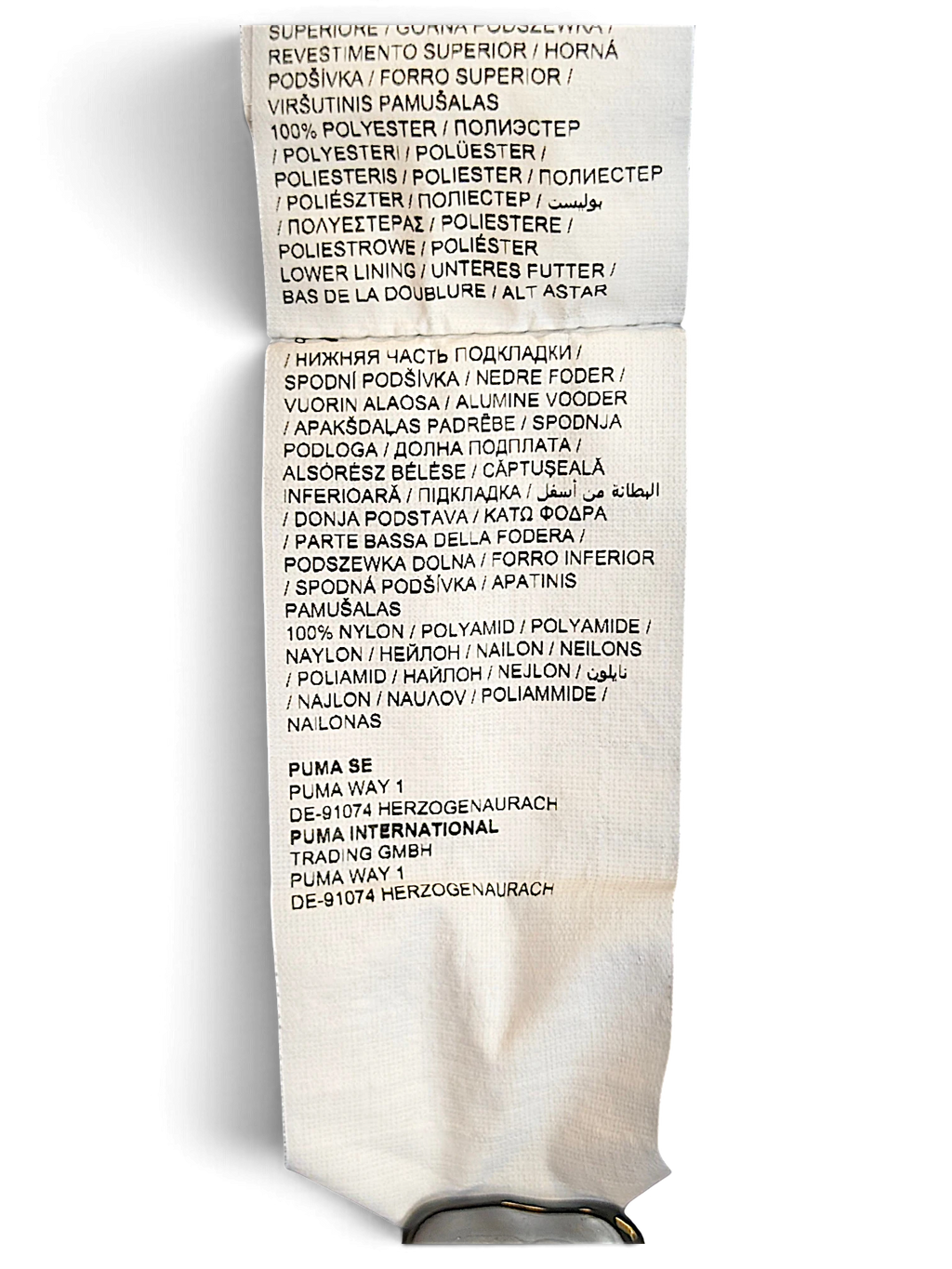 JAKE & IPI Puma track pants care and material label showing 100% polyester and 100% nylon composition details