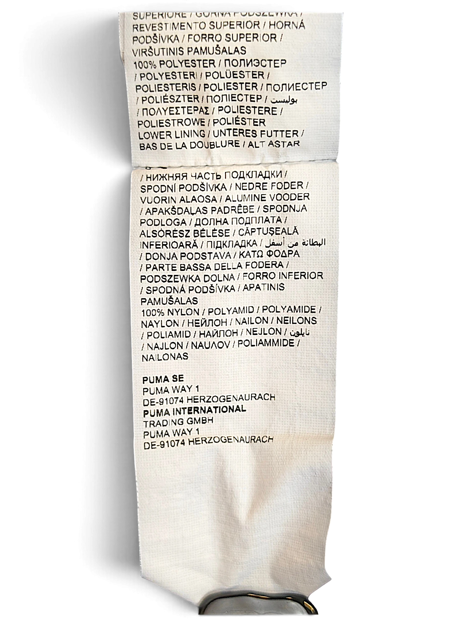 JAKE & IPI Puma track pants care and material label showing 100% polyester and 100% nylon composition details