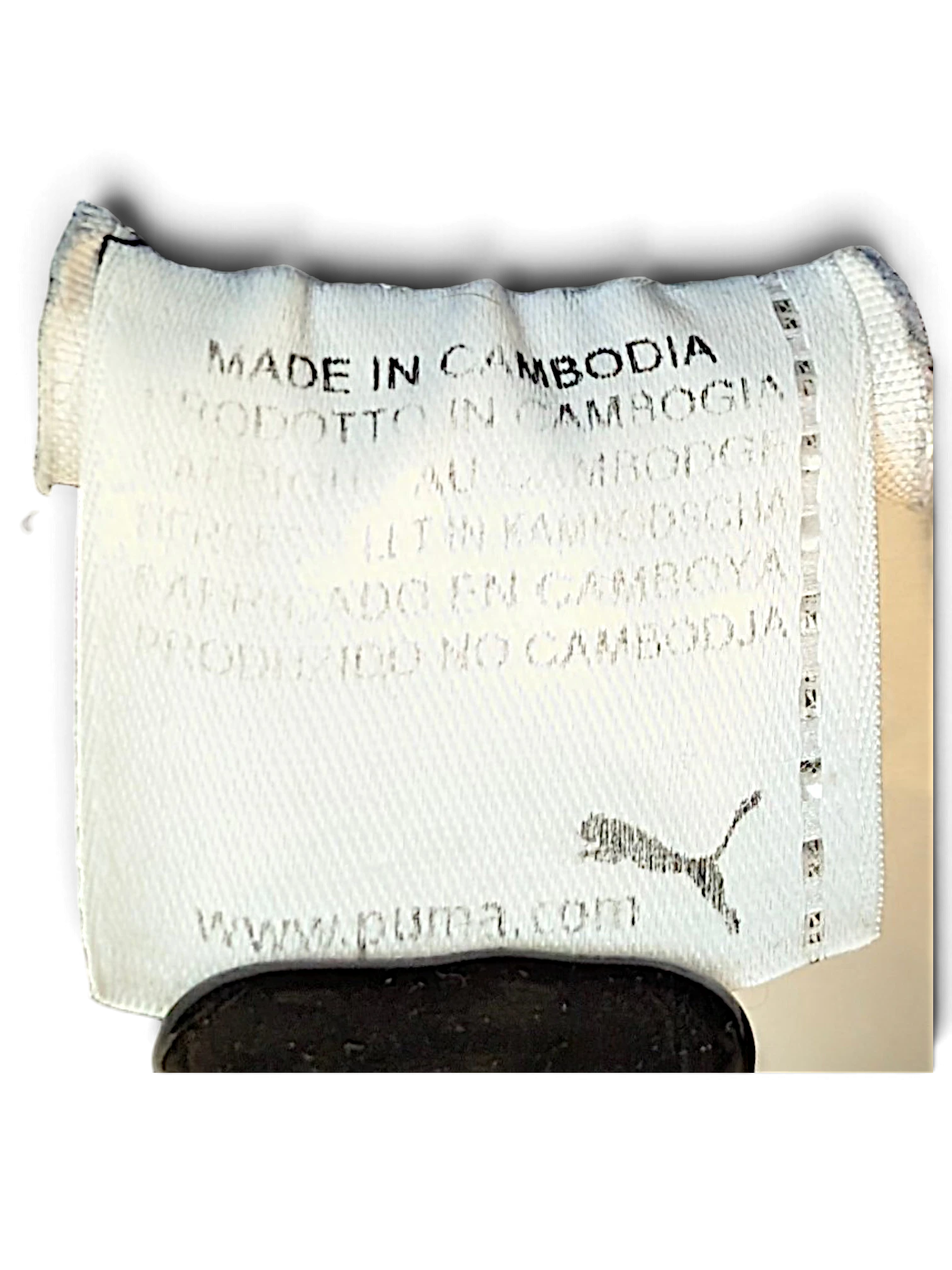 JAKE & IPI Puma track pants white fabric care label showing Made in Cambodia text and Puma logo