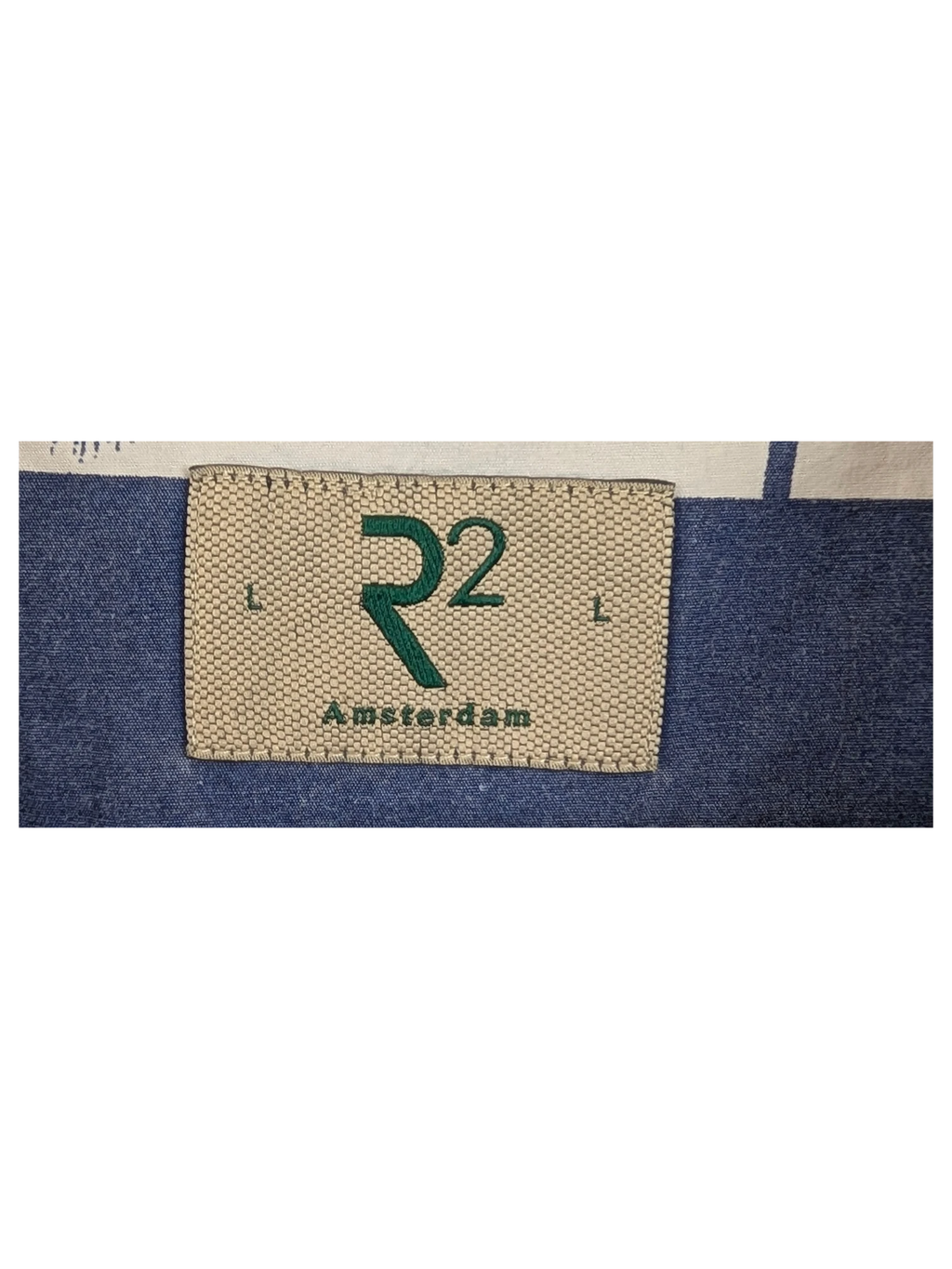 JAKE & IPI R2 Amsterdam Hawaiian shirt featuring a blue and white palm tree print on a wooden hanger