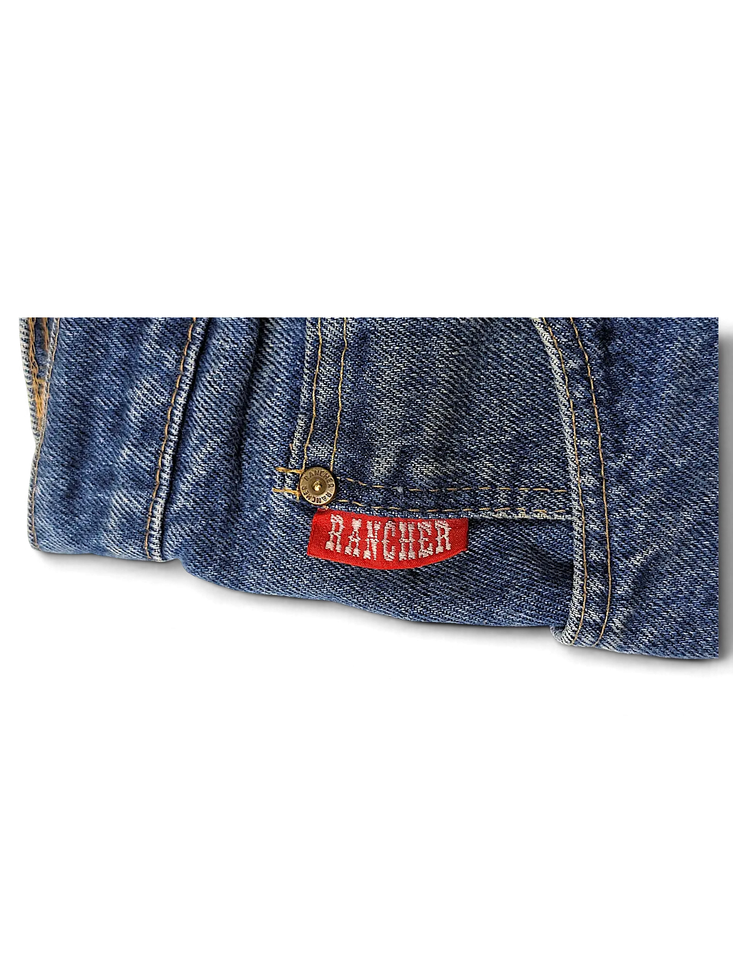 JAKE & IPI Rancher jeans in dark blue denim with a red brand label and metallic rivet detail.