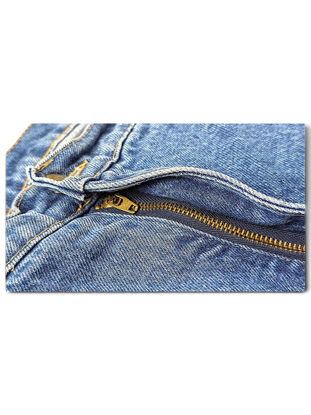 Close-up of JAKE & IPI Rancher jeans featuring blue denim fabric and a brass metal zipper fly detail.