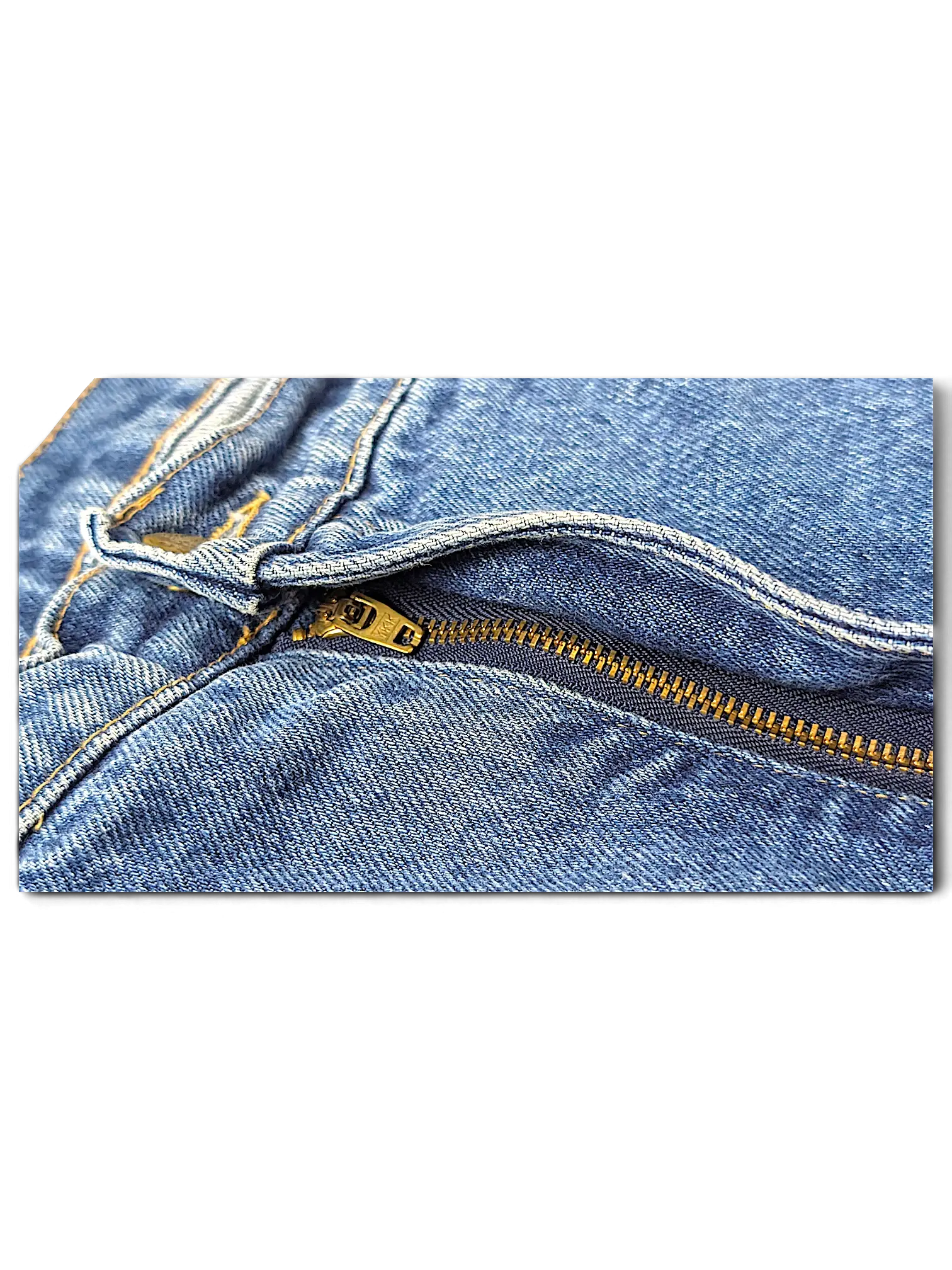 Close-up of JAKE & IPI Rancher jeans featuring blue denim fabric and a brass metal zipper fly detail.
