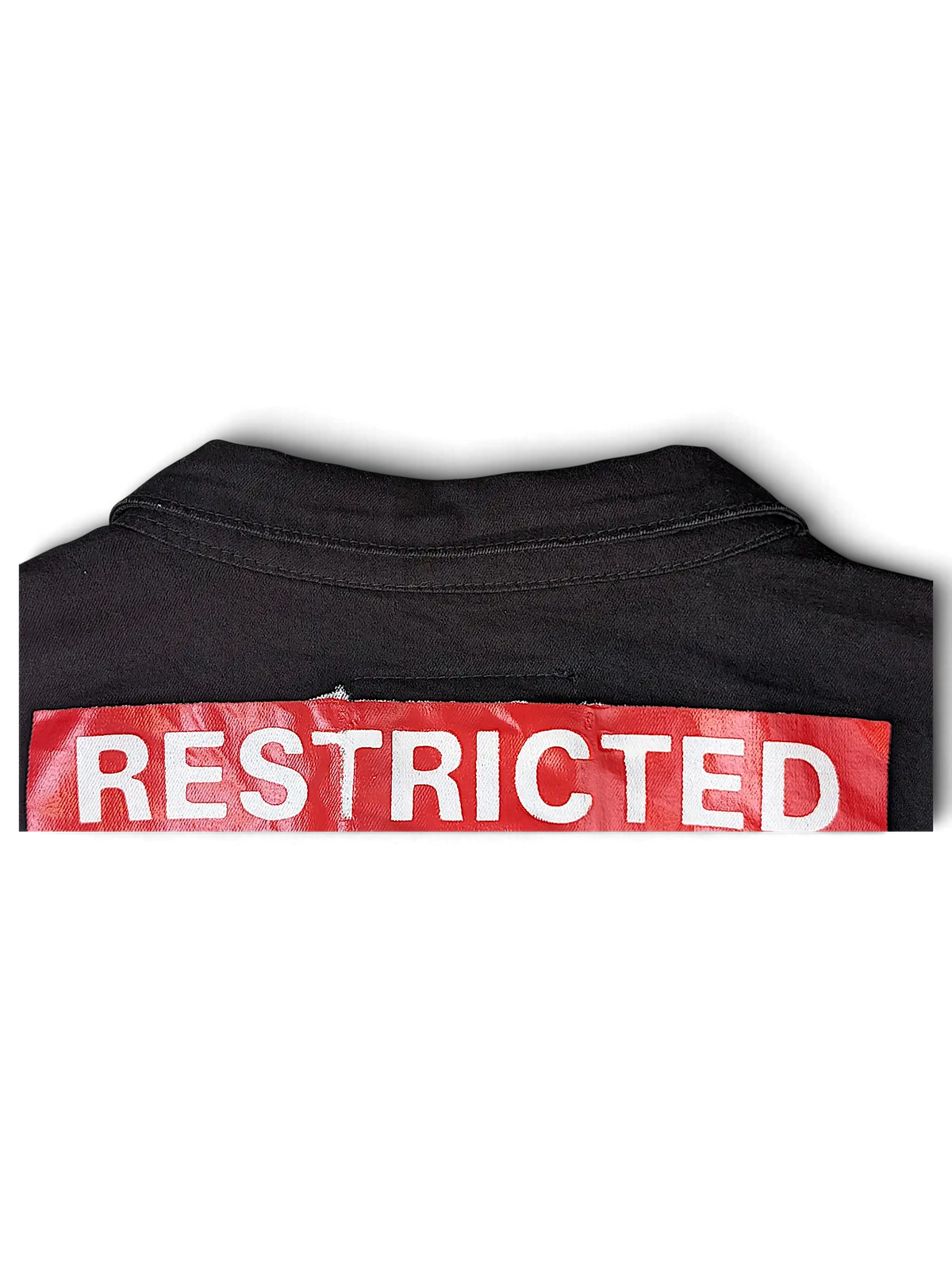 JAKE & IPI Reason black denim jacket featuring a bold red and white RESTRICTED patch on the back collar