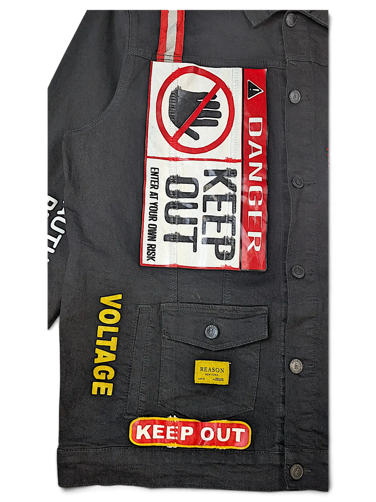JAKE & IPI Reason denim jacket in black featuring bold Danger and Keep Out warning patches and yellow Voltage text