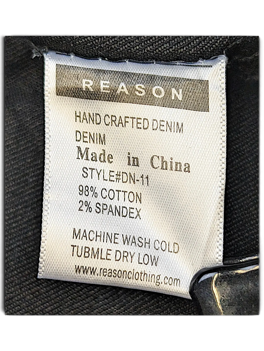 JAKE & IPI Reason denim jacket care label showing 98 percent cotton and 2 percent spandex material composition