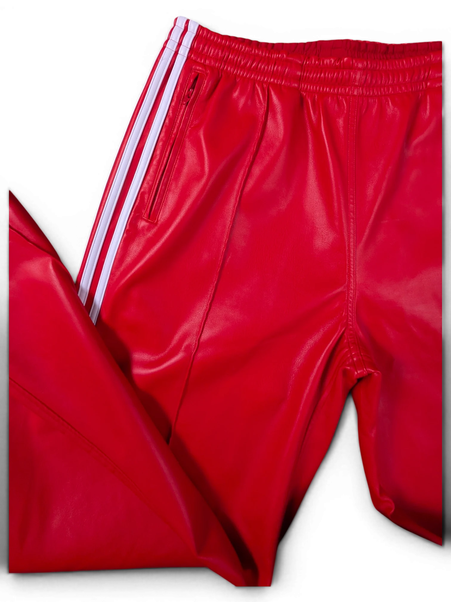 JAKE & IPI red Adidas leather pants with iconic white side stripes and zippered pockets.