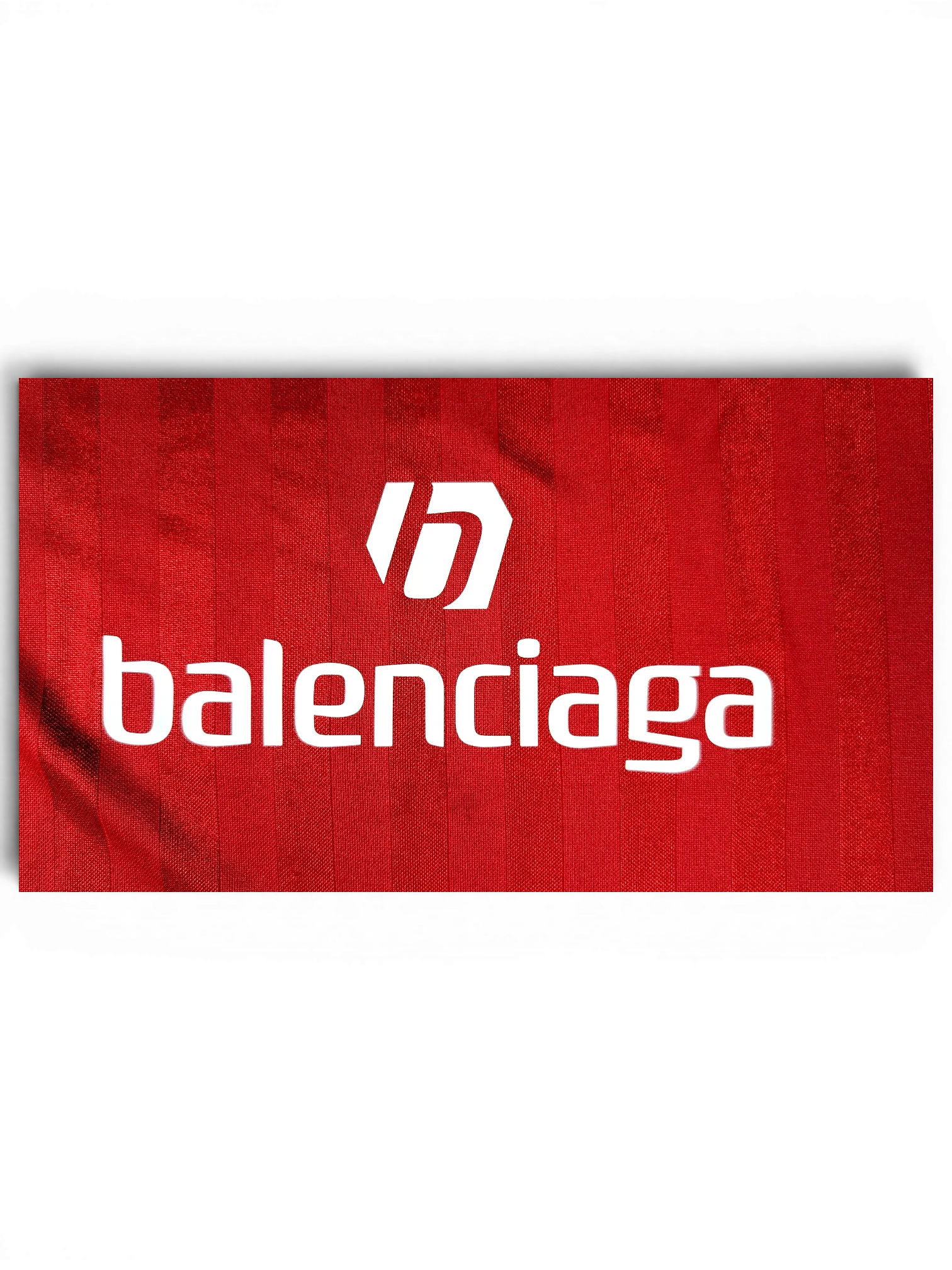 JAKE & IPI red Balenciaga x Adidas collaborative jersey with white logo branding on textured fabric